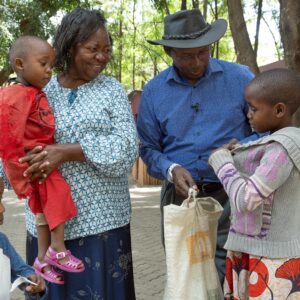 A man in a cowboy hat and a woman holding a toddler with two children at MCF